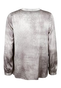 Long-sleeve shirt in soft, textured fabric. Predominantly gray with a subtle abstract pattern. Features a round neckline and buttoned cuffs.