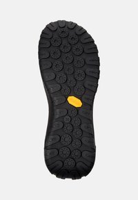 Black rubber shoe sole featuring a textured surface with circular patterns, Vibram logo in yellow, and size marking '38'.