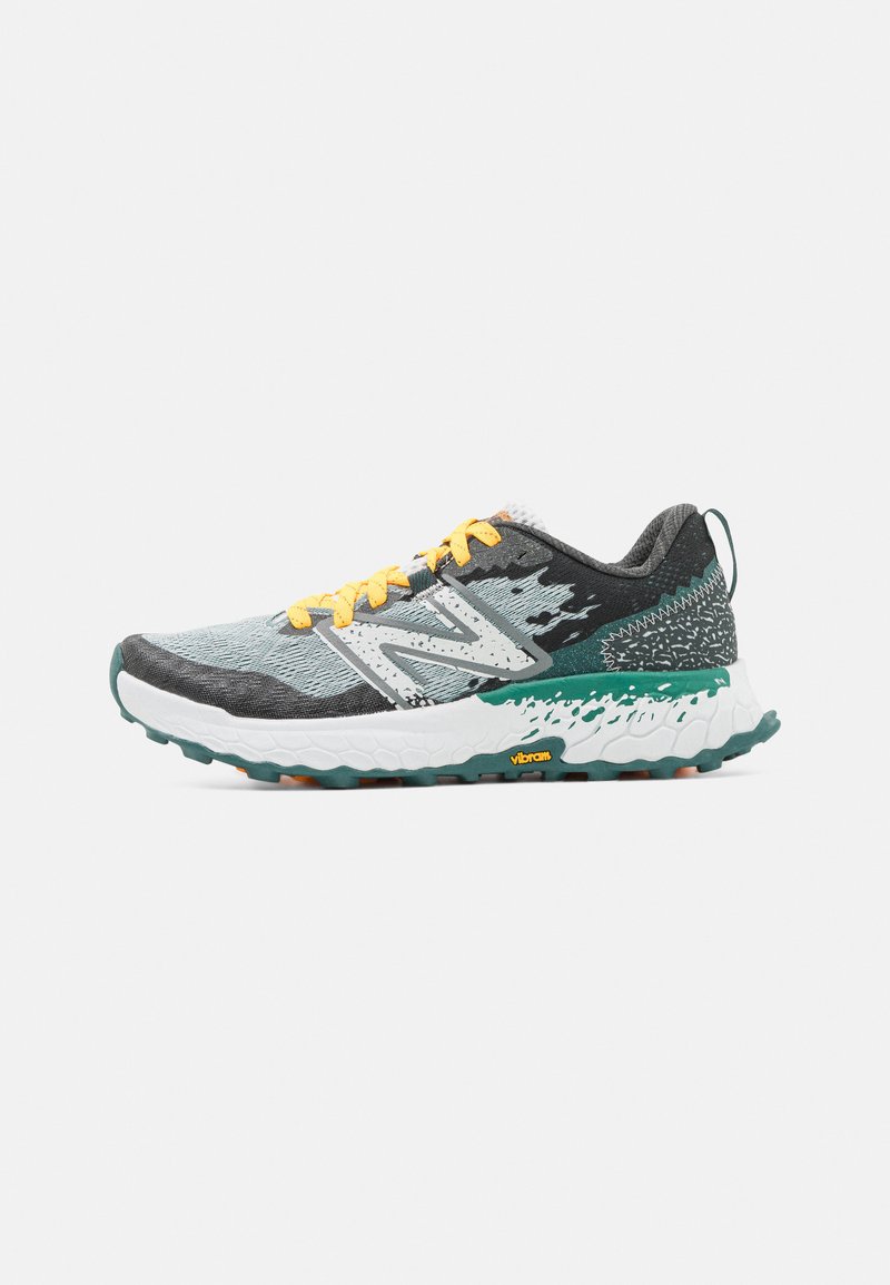 Trail running shoe with a grey, textured mesh upper, yellow laces, white midsole, green outsole, and black accents. Vibram logo present.