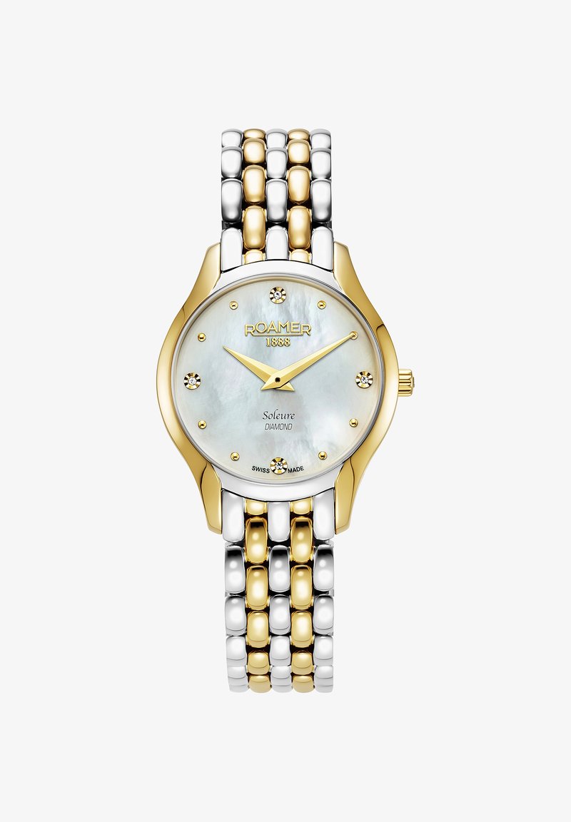 Złoto- i srebrno-tonowy zegarek metalowy z okrągłą tarczą z masy perłowej, akcentami diamentowymi oraz bransoletą z ogniw. Posiada wyraziste, złote wskazówki godzinową i minutową.