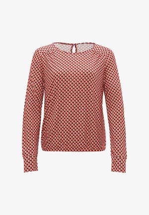 Blusa a maniche lunghe con motivo geometrico in rosso, nero e crema, con scollatura tonda e dettaglio a chiave sulla schiena. Realizzata in tessuto leggero.