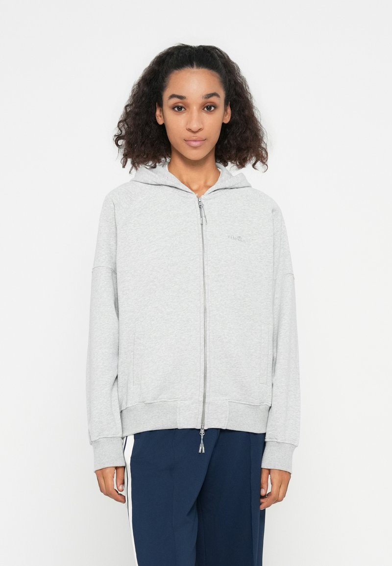 Gray zip-up hoodie made of soft cotton material, featuring a hood, ribbed cuffs, and a simple logo on the left chest.