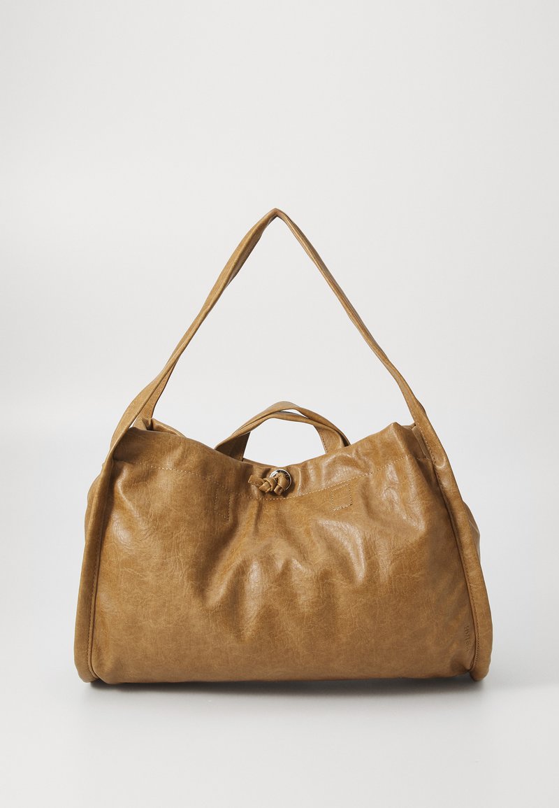 Tan leather bag with a soft, textured surface, featuring two handles and a knot detail at the top. The design is spacious and slouchy.