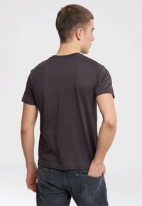 Dark gray cotton t-shirt with short sleeves, crew neck, and a smooth texture, viewed from the back. Casual fit with minimal detailing.