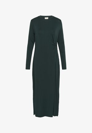 Langärmliges, dunkelgrünes Kleid aus weichem, elastischem Stoff. Verfügt über ein seitliches Knoten-Detail und einen Oberschenkel-spitzens Schlitz auf einer Seite.