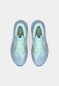 Ανοιχτό μπλε αθλητικά παπούτσια με επάνω μέρος από δίχτυ, γκρι λεπτομέρειες, διάτρητη υφή και ανακλαστικά στοιχεία. Διαθέτουν φωτεινά κορδόνια νέον κίτρινου χρώματος.