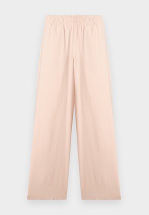 Beige vide bukser med elastisk midjebånd, jevn tekstur og uten synlige lommer, vist flatt på hvit bakgrunn.