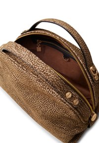 Textured brown leather handbag with a zippered top, featuring gold hardware and a fabric lining. Interior includes a small pocket.