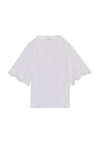 White short-sleeve top with a V-neck, eyelet detail on sleeves, and a textured fabric featuring small holes for breathability.