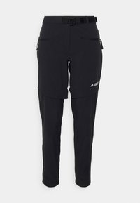 Pantalon de randonnée convertible noir avec jambes zippées amovibles, ceinture ajustable, poches zippées et logo Terrex sur la cuisse droite.
