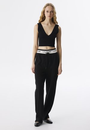 RELAXED FIT SLOGAN JACQUARD - Jogginghose - black