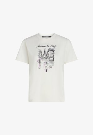 Valkoinen puuvillapaita, jossa on graafinen printti katunäkymästä, jossa on mustia ja purppuran värisiä rakennuksia ja hahmoja.