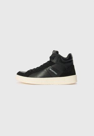 Black high-top sneakers with smooth and suede leather textures, white rubber sole, tonal stitching, and a small logo patch on the side.
