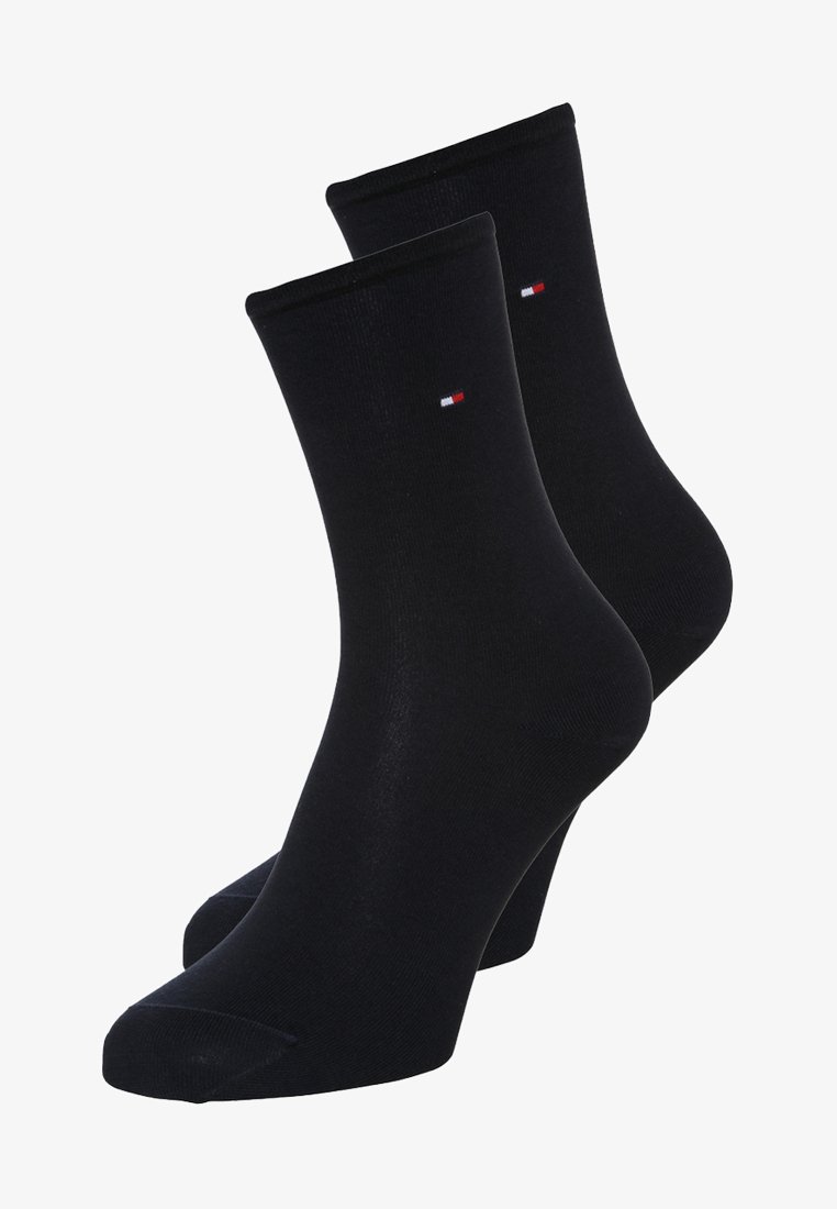 Black cotton ankle socks with a ribbed cuff, featuring a small red, white, and blue logo at the top. Smooth texture, standard fit.