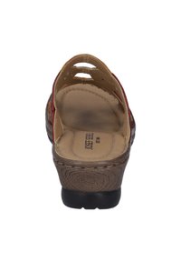 Open-toe sandal featuring a brown textured sole, light brown insole, and multicolored straps with cut-out design.