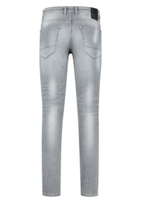 Graue Jeans aus Denim mit schmaler Passform, ausgestattet mit zwei Gesäßtaschen, leichter Ausbleichung und einem schwarzen Etikett am Bund.