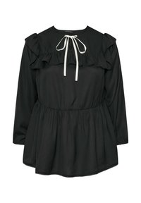 Musta pitkähihaista puseroa, jossa on frilliyksityiskohta olkapäillä ja vyötäröllä, pyöreä pääntie ja valkoinen nauhatyyny etuosassa.