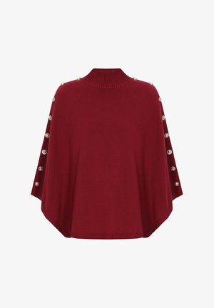 Czerwony dzianinowy ponczo z wysokim kołnierzem, ozdobione dekoracyjnymi guzikami na ramionach i zaokrąglonym dołem. Gładka tekstura i luźny krój.