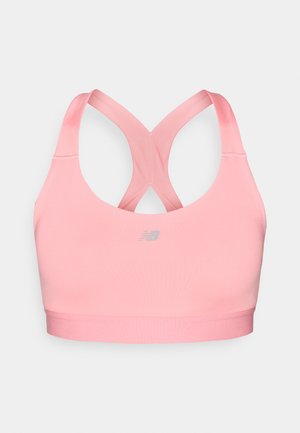 Brassière de sport rose en tissu lisse, avec dos nageur et ourlet renforcé. Comprend un petit logo dans une teinte plus claire à l'avant.