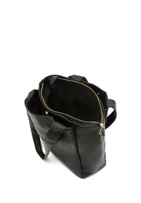 Black leather tote bag with a glossy finish, featuring a zippered top, gold hardware, and two sturdy handles. Spacious interior lining visible.