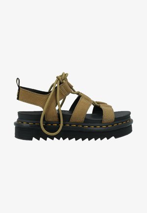 Tan suede sandal with adjustable laces, open heel, and black platform sole featuring zigzag pattern and yellow accent stitching.