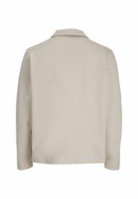 Lichtbeige langemouwen shirt met een kraag, voorzien van een gladde textuur en rechte snit, ontworpen in een minimalistische stijl zonder zichtbare sluitingen.