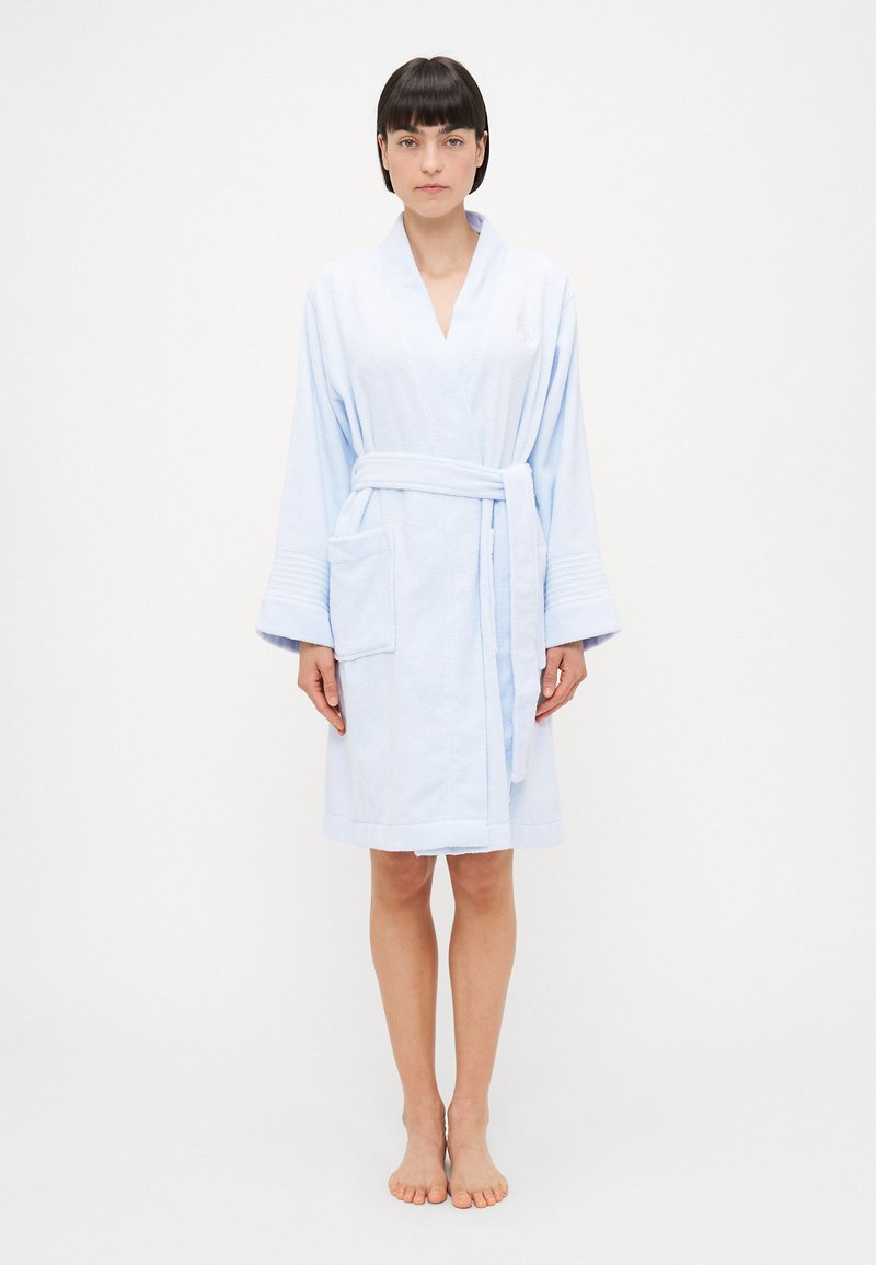 Light blue terry bathrobe with a wrap design, waist tie, wide sleeves, and two front pockets. Soft texture with a plush finish.