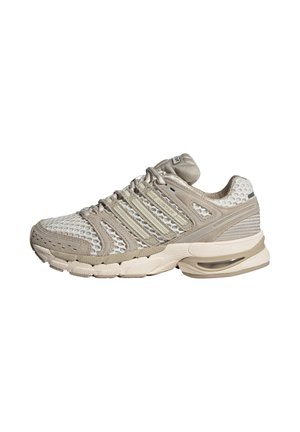 Beige and white athletic sneaker with mesh and suede upper, cushioned sole, air pocket in heel, and lace-up closure.