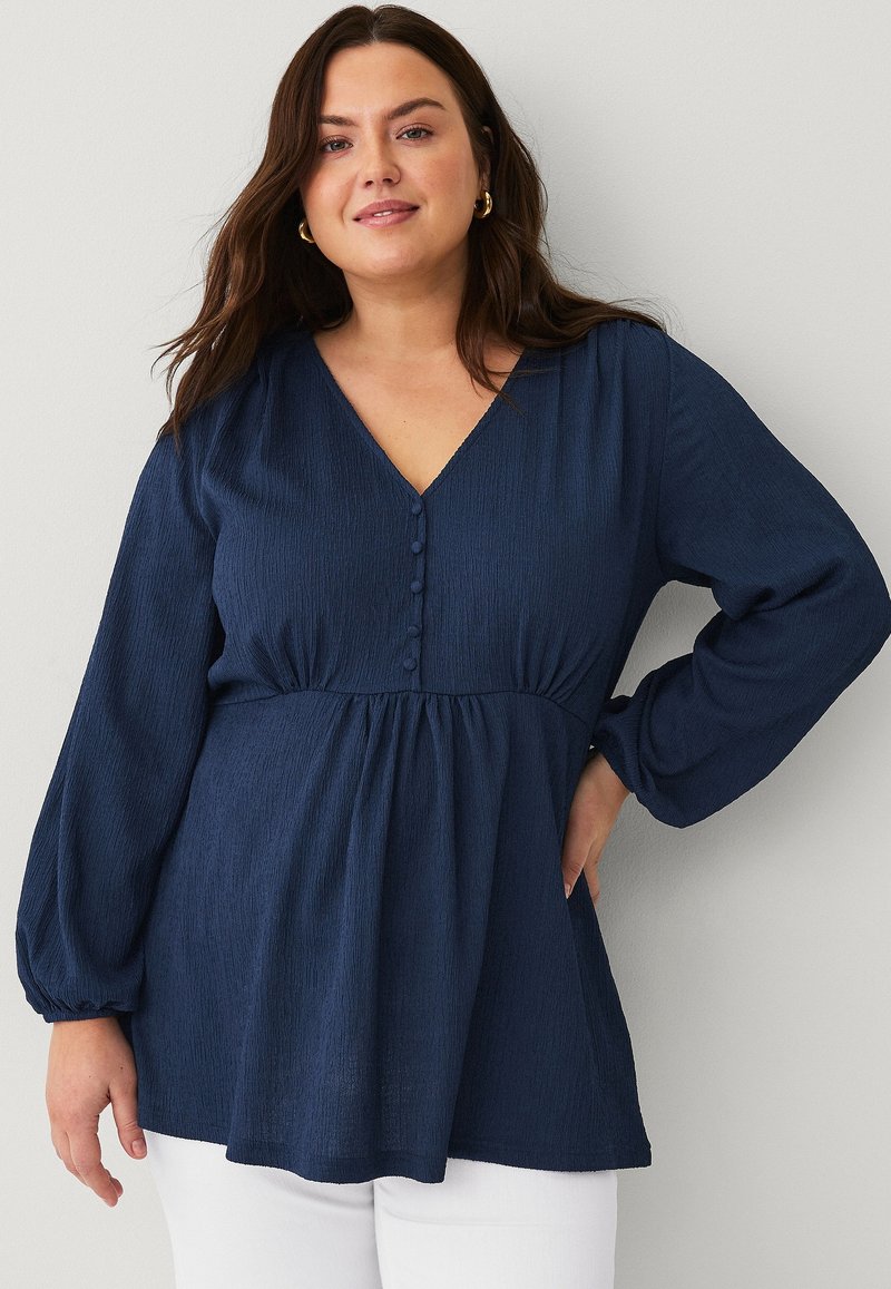 Navy blue long-sleeve blouse with a V-neckline, textured fabric, gathered waist, and five button detailing at the front.