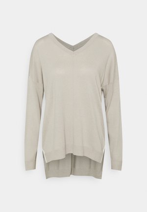 Lichtbeige V-hals trui met lange mouwen, een losse pasvorm en een iets langere achterkant.