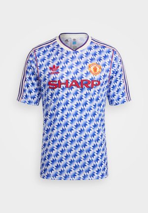 Manchester Unitedin sinivalkoinen siksak-kuvioinen jalkapallopaita, jossa on punainen Adidas-logo, Sharpin sponsori ja seuran vaakuna rinnassa.