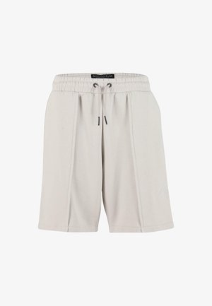 Világosszürke, puha anyagú nadrág, rugalmas derékpánttal és húzózsinórral, oldalsó zsebekkel és finom logóval.