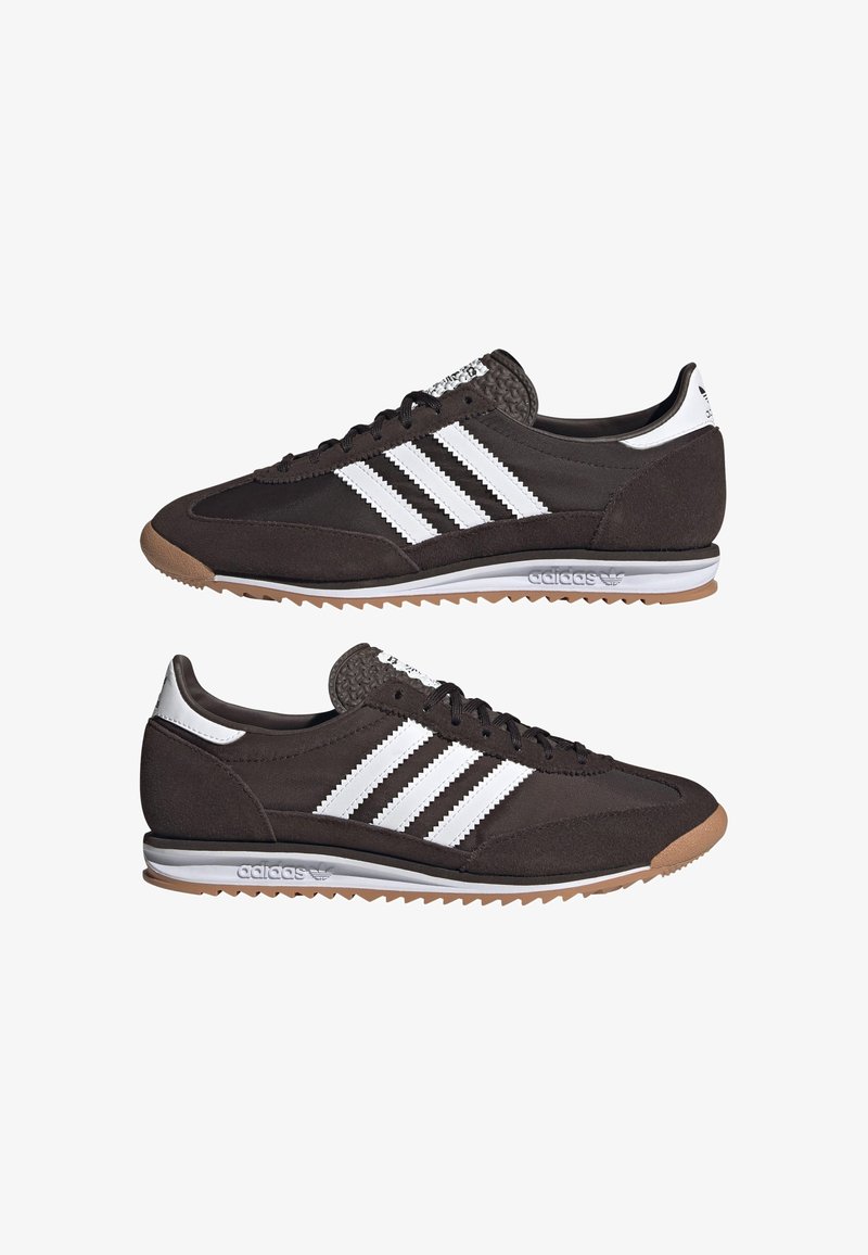 Brown suede sneakers featuring three white stripes, textured accents, a rubber sole, and a cushioned collar for support.