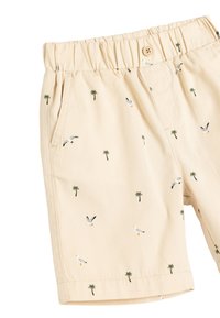 Beige Shorts mit elastischem Bund, versehen mit kleinen Drucken von Palmen und Möwen. Hergestellt aus leichtem Stoff mit Seitentaschen.