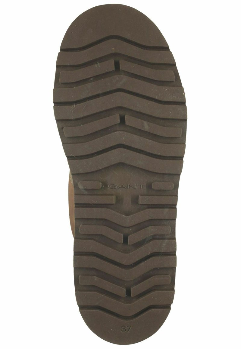 Brun gummiskosula med texturerade vågiga mönster, med en framträdande "GANT"-logga och storlek "37" tryckt nära tåområdet.