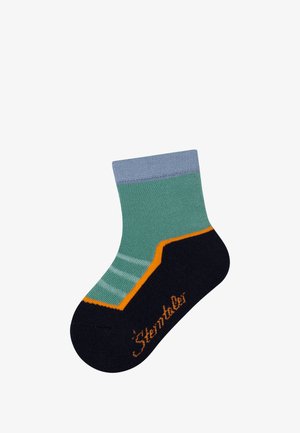 Colorful sock with blue cuff, green body, and navy foot. Features orange accent and striped pattern on the midsection. Soft, knitted texture.