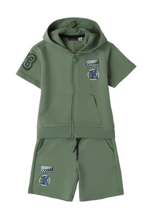 Green cotton zip-up hoodie and matching shorts, featuring pockets, "3" patch, and "GO KART" graphics. Soft texture, casual athletic design.