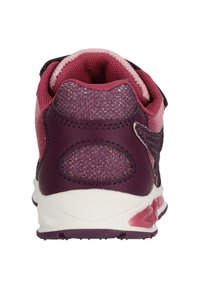 Purple and pink athletic shoe featuring a textured upper, padded collar, and adjustable strap. Soles show pink accents and rounded shape.