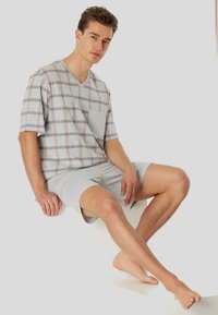 Gray plaid short-sleeve V-neck T-shirt with a pocket, paired with gray shorts. Casual cotton blend, relaxed fit, and smooth texture.