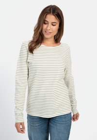 Stribet langærmet top i lys krem med olivengrønne striber, har en rund halsudskæring og blødt, tekstureret stof. Sammen med denim jeans.