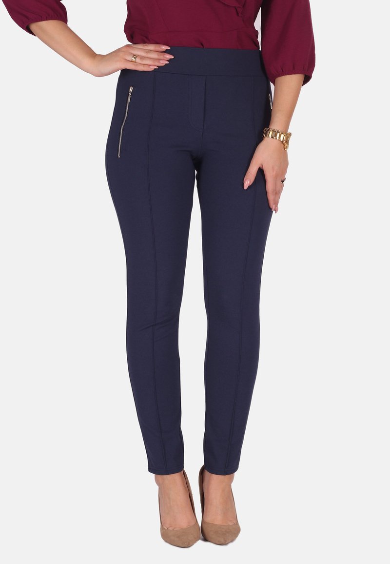 Marineblaue Leggings mit hohem Bund, ausgestattet mit einer seitlichen Reißverschlusstasche und vertikalen Nahtdetails für ein elegantes, körperbetontes Design.