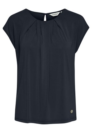 Navy blue, short-sleeve blouse with pleated front detail and keyhole back. Features a small metallic logo accent near the hem. Soft fabric.
