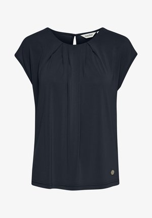 Blouse bleu marine à manches courtes avec un détail plissé sur le devant et une ouverture en forme de clef à l'arrière. Présente un petit accent logo métallique près de l'ourlet. Tissu doux.