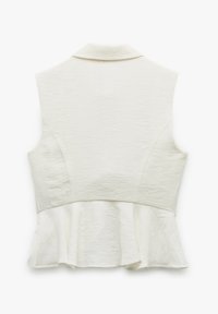 Hvid peplum-top med krave, uden ærmer og tekstureret stof, der har en flaret talje og en subtil glans.