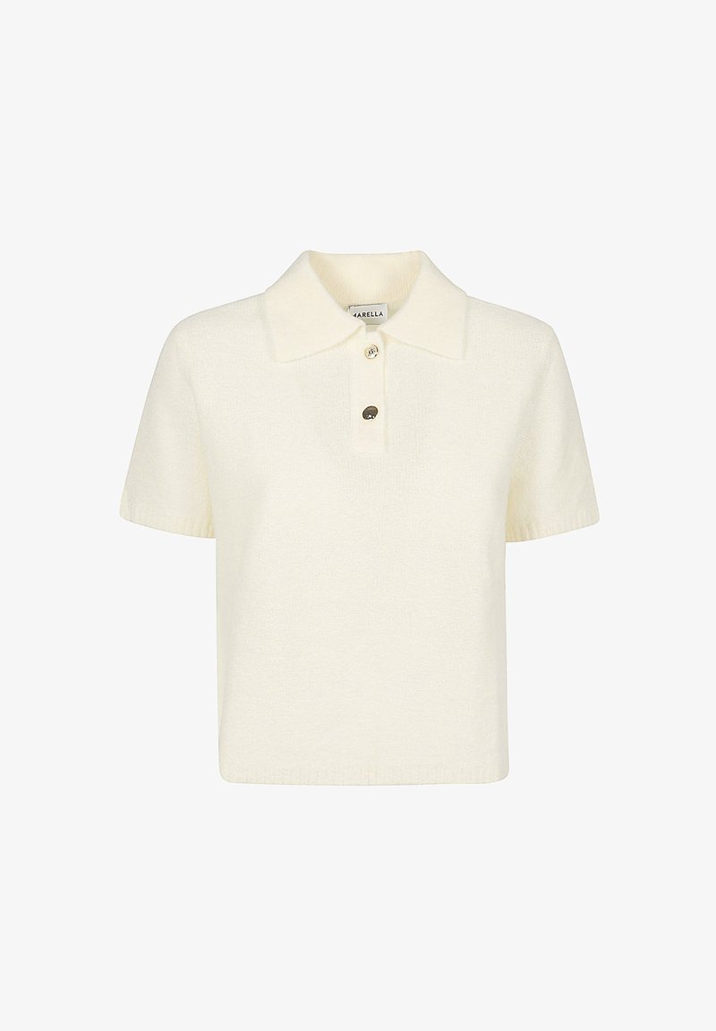 Polo a maniche corte di colore crema, realizzato in maglia, con colletto classico e patta a tre bottoni. Tessuto morbido con una vestibilità rilassata.