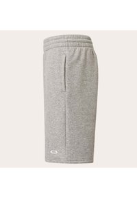 Graue Sportshorts mit elastischem Bund, Seitentaschen und Logodetail. Hergestellt aus weichem, atmungsaktivem Stoff mit glatter Textur.