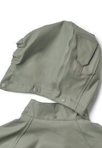 Wodoodporna kurtka z kapturem w kolorze oliwkowej zieleni, z marszczonymi detalami i zatrzaskami. Charakteryzuje się teksturowaną naszywką i gładkim wykończeniem.