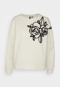 White sweatshirt featuring a black embroidered rose design on the left shoulder. Soft texture, loose fit, and ribbed cuffs.
