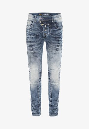 Jean en denim décoloré de bleu avec une coupe slim, comportant plusieurs boutons, des motifs de couture uniques et une texture usée sur les cuisses.