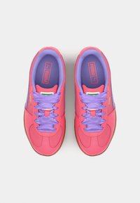 Puma sneakers featuring a pink and purple design, fabric upper, purple laces, and a rubber sole. Includes branding on the tongue.